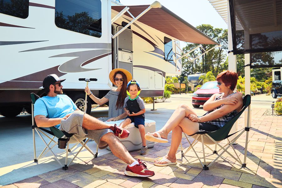 RV Insurance - Family Camped Outside Talking About the Vacation