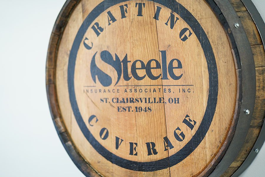 We Are Independent - View of Steele Insurance Logo on Oak Barrel Hanging on Wall in Office